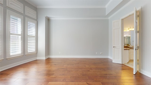 unfurnished room featuring hardwood / wood-style flooring and ornamental molding