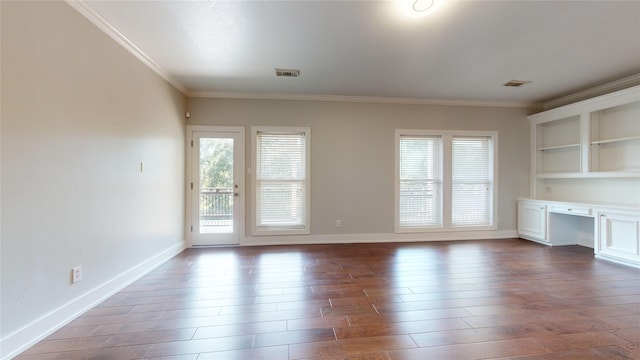 unfurnished living room with hardwood / wood-style flooring, built in desk, and crown molding