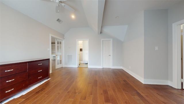 unfurnished bedroom with lofted ceiling with beams, ceiling fan, and wood-type flooring