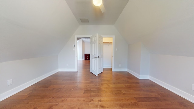 additional living space featuring hardwood / wood-style floors, ceiling fan, and vaulted ceiling