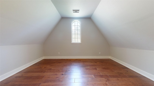 bonus room with lofted ceiling and dark hardwood / wood-style floors