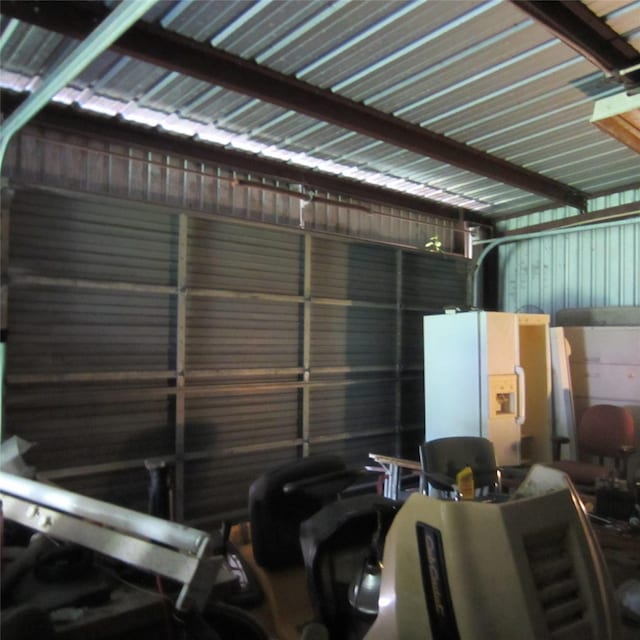 garage with white refrigerator with ice dispenser