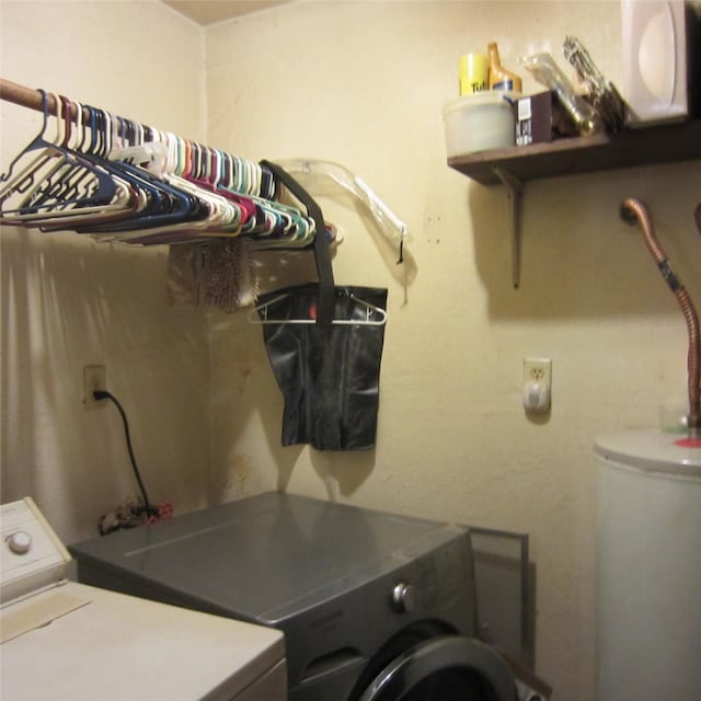 laundry room with water heater and independent washer and dryer