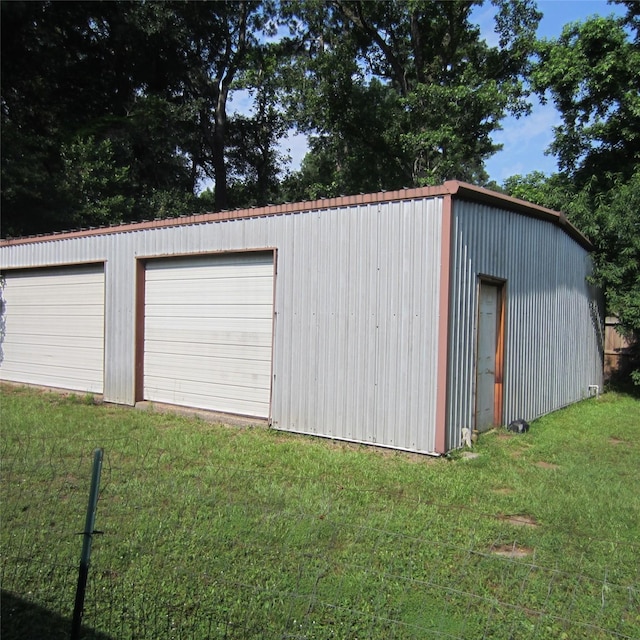 garage featuring a lawn