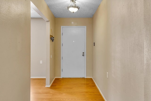 entryway featuring a textured ceiling and hardwood / wood-style flooring