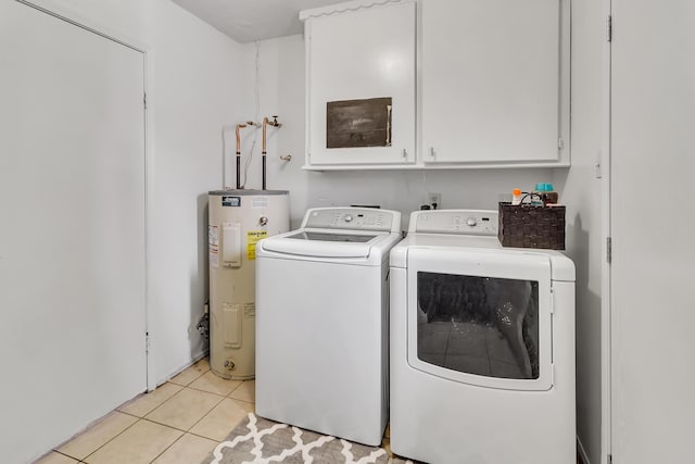 laundry area with water heater, light tile patterned floors, cabinets, and independent washer and dryer