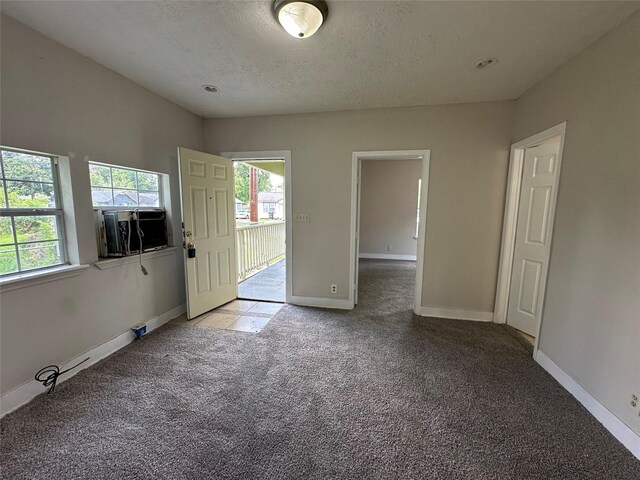 4520 Falls St, Houston, TX 77026 - foyer with light colored carpet, baseboards, and a textured ceiling