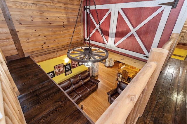 stairway featuring wooden walls and wood-type flooring