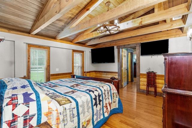 bedroom with wooden ceiling, hardwood / wood-style flooring, and lofted ceiling with beams