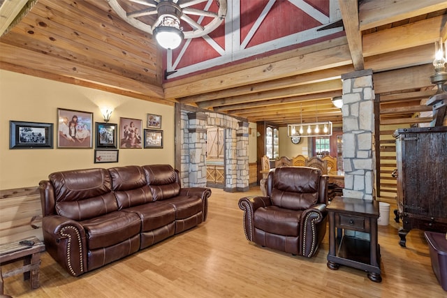 living room with lofted ceiling with beams, wooden ceiling, hardwood / wood-style flooring, ornate columns, and ceiling fan