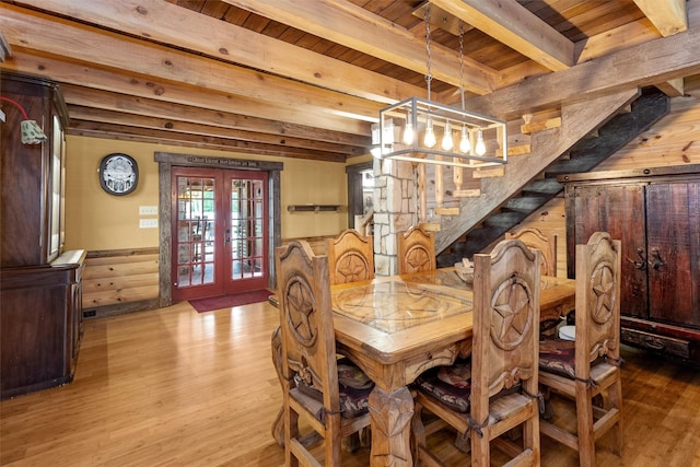 dining room featuring beam ceiling, french doors, hardwood / wood-style flooring, and wooden ceiling