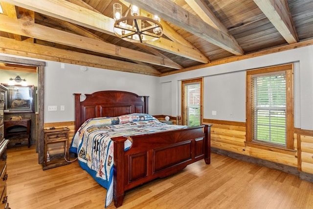 bedroom featuring lofted ceiling with beams, light hardwood / wood-style flooring, and wooden ceiling