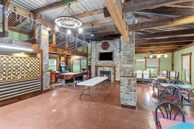 interior space with a fireplace, billiards, concrete flooring, and lofted ceiling with beams