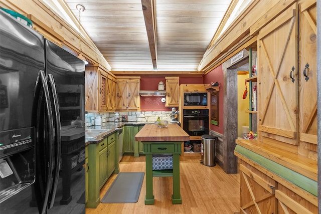 kitchen with vaulted ceiling, wood counters, backsplash, black appliances, and green cabinetry