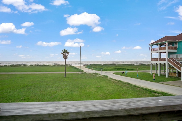 surrounding community featuring a water view and a lawn