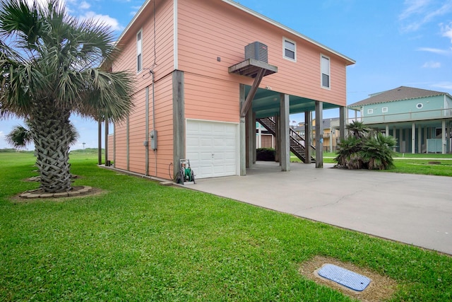 view of front of house featuring a garage and a front lawn