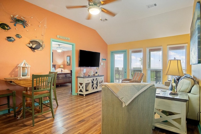 living room featuring lofted ceiling, wood-type flooring, and ceiling fan