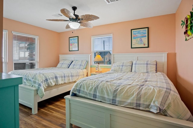 bedroom with dark wood-type flooring and ceiling fan