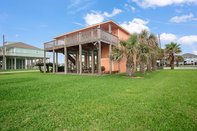 rear view of house with a wooden deck and a yard