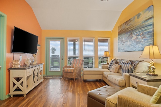 living room featuring dark wood-type flooring and lofted ceiling