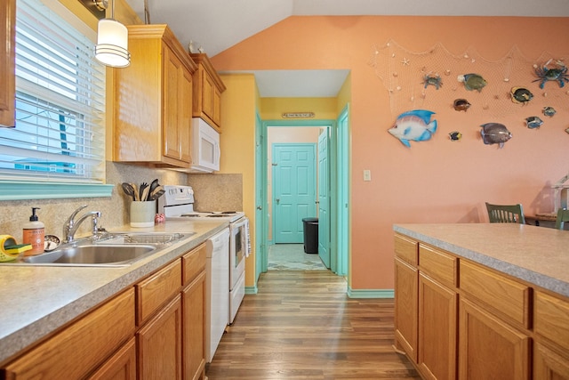 kitchen featuring sink, hanging light fixtures, hardwood / wood-style flooring, white appliances, and backsplash