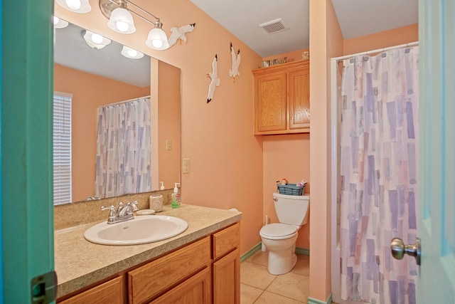 bathroom with vanity, curtained shower, tile patterned floors, and toilet