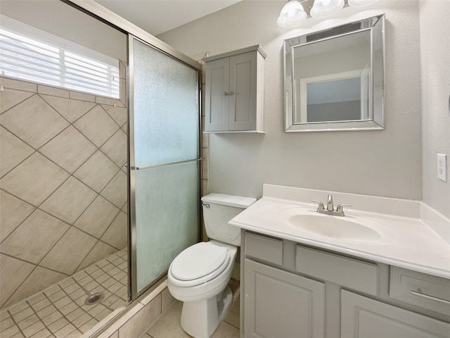 bathroom with vanity, toilet, an enclosed shower, and tile patterned floors