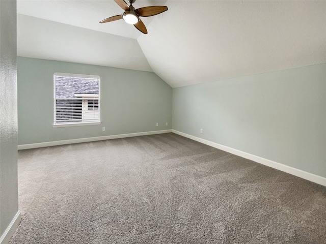 additional living space featuring vaulted ceiling, ceiling fan, and carpet flooring