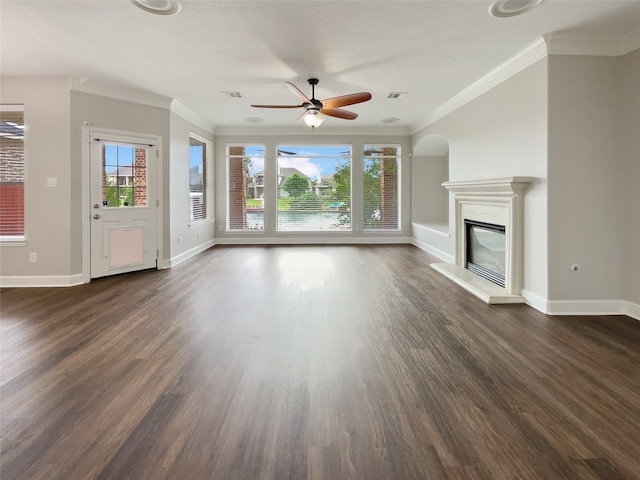 unfurnished living room featuring ceiling fan, dark hardwood / wood-style floors, and ornamental molding