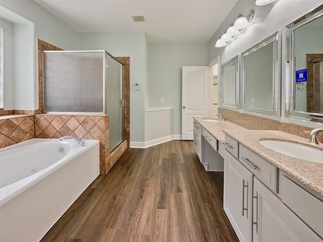 bathroom with vanity, independent shower and bath, and wood-type flooring