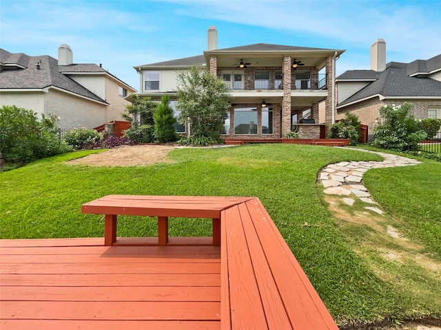 exterior space with ceiling fan and a lawn