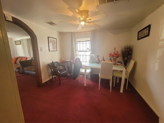 carpeted dining area with ceiling fan