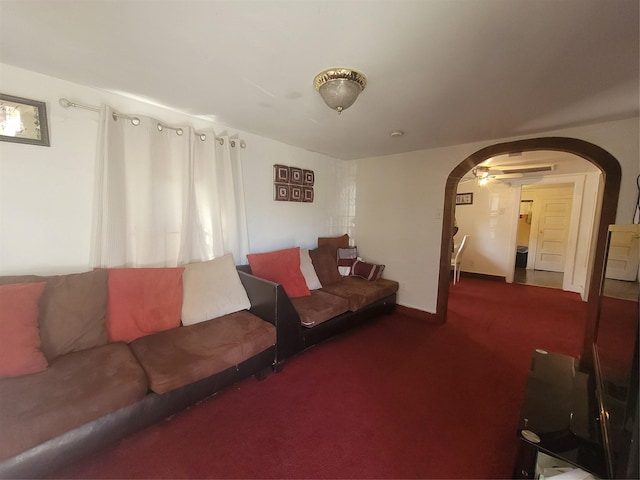 living room with dark colored carpet and ceiling fan