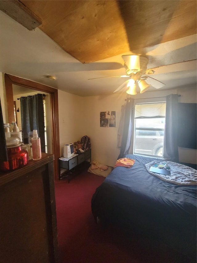 bedroom with dark colored carpet and ceiling fan