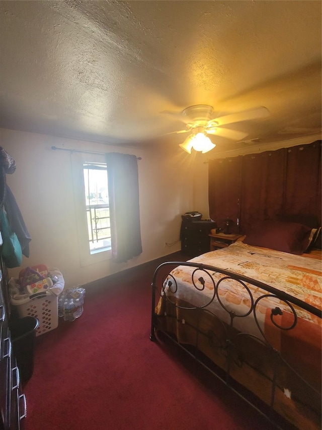 carpeted bedroom featuring a textured ceiling and ceiling fan