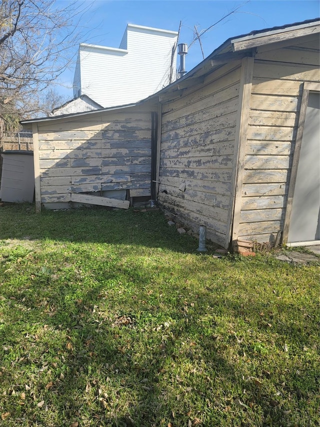 view of side of property with a lawn