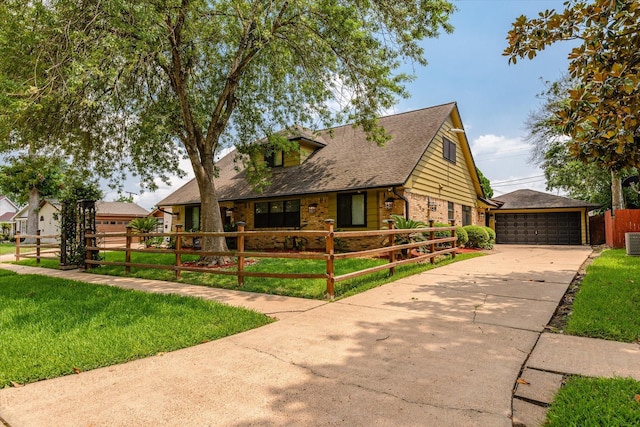 cape cod house featuring a garage, central AC, and a front lawn