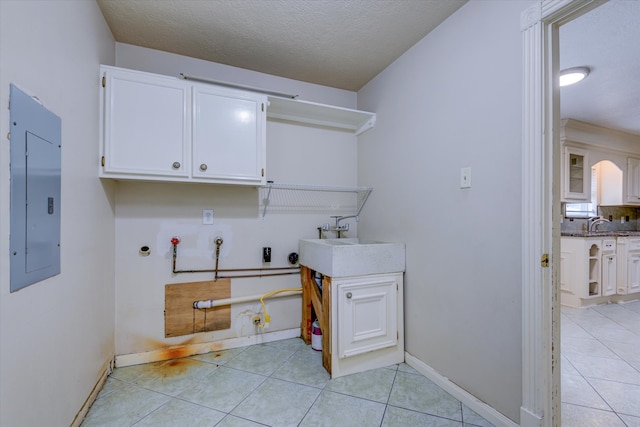 washroom with sink, hookup for a washing machine, electric panel, cabinets, and hookup for a gas dryer