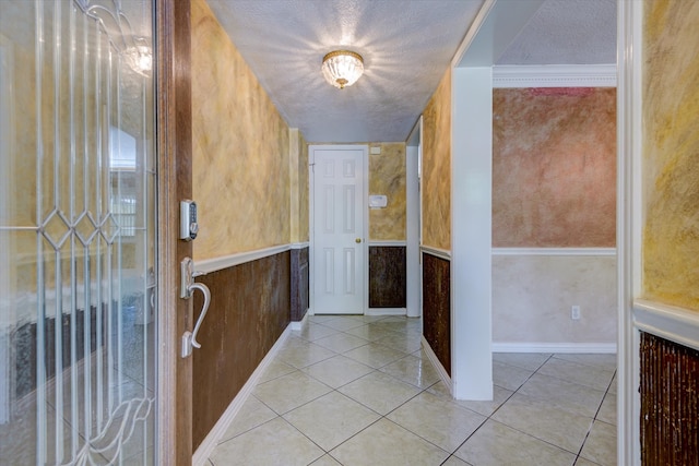 entrance foyer with light tile patterned floors and a textured ceiling