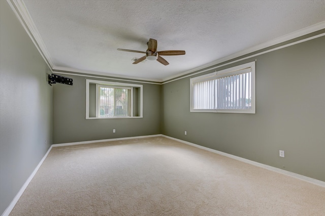 carpeted empty room featuring ceiling fan, crown molding, and a textured ceiling