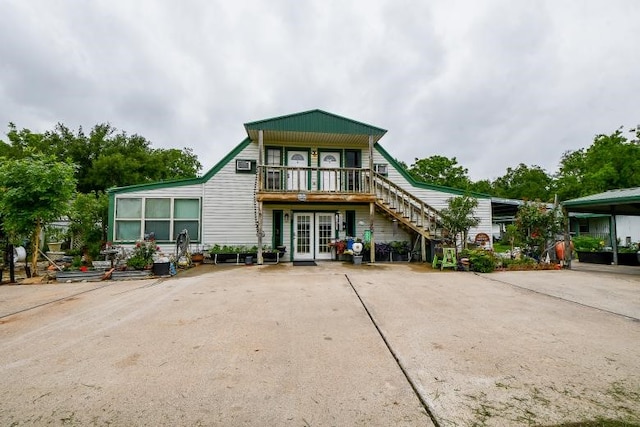 view of front of house with french doors and a carport