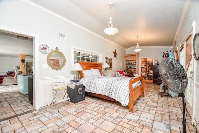 tiled bedroom with ornamental molding, a textured ceiling, and lofted ceiling