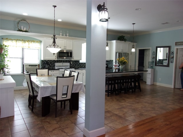 tiled dining space featuring ornamental molding