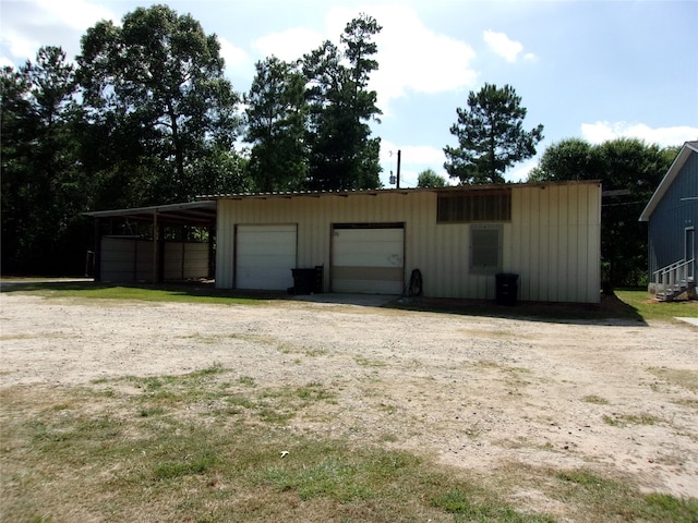 view of outdoor structure featuring a garage and a carport