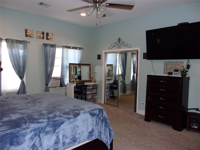 carpeted bedroom with a closet and ceiling fan