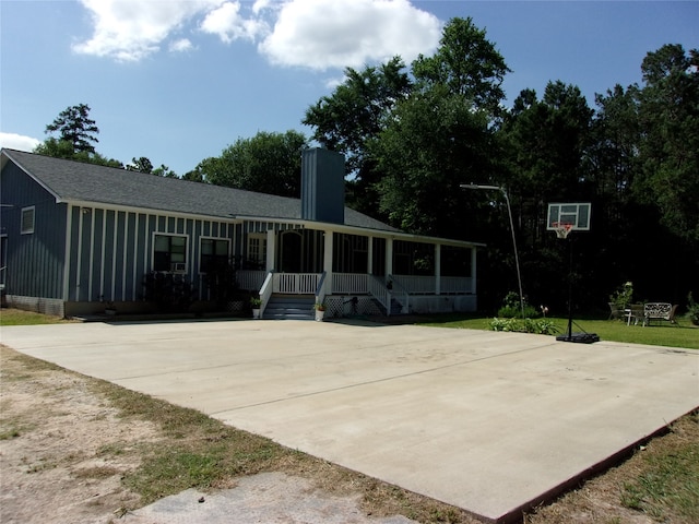 view of sport court featuring a lawn