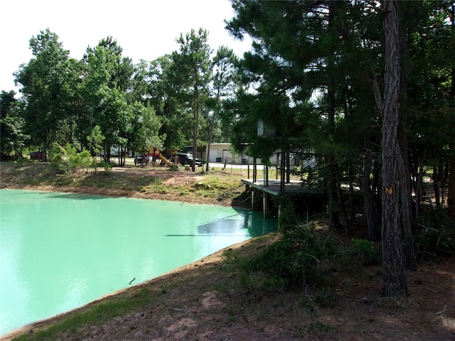 view of swimming pool featuring a playground