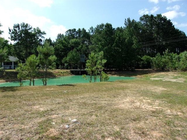 exterior space featuring a lawn and a water view