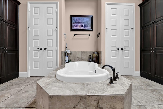 bathroom featuring a relaxing tiled tub