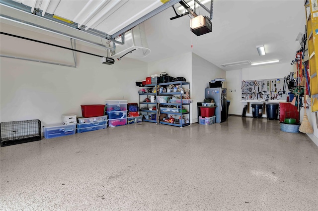 garage featuring a garage door opener and stainless steel refrigerator